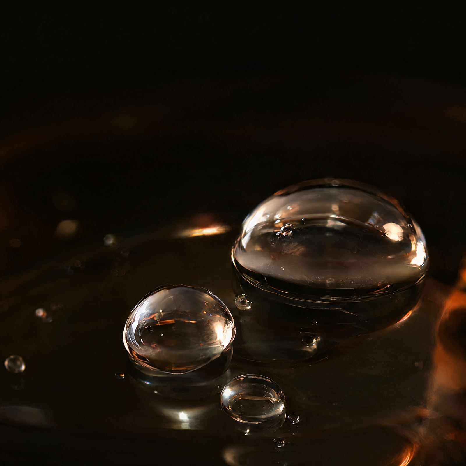 Clear gel droplets on dark glass
